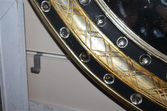 A pair of Irish style oval mirrors with glass-mounted gilt and ebonised frames H.105cm